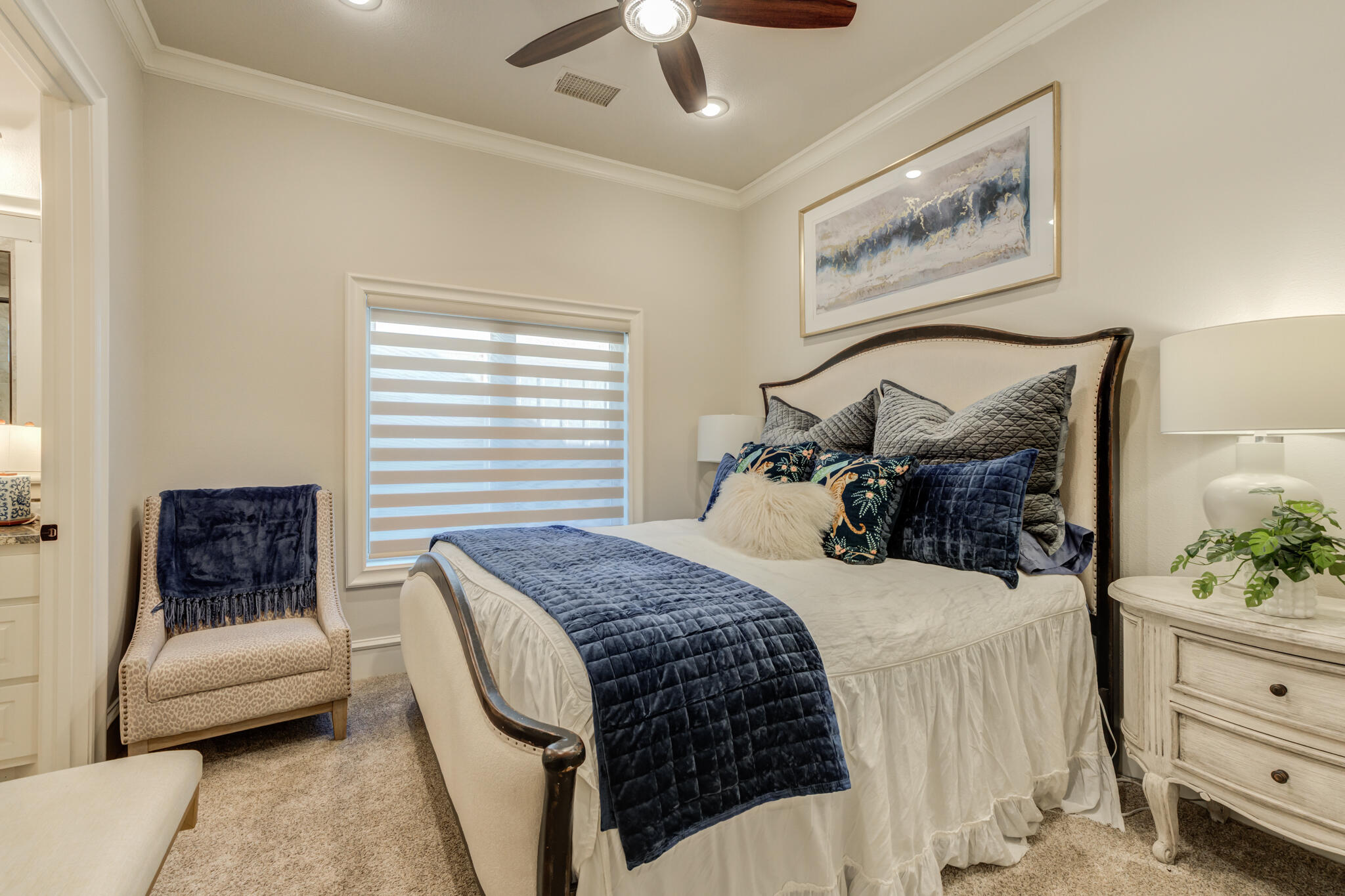 5006 117th Street Lubbock, TX 79424 - Photo 41 of 88 a bedroom with a bed a couch and a chandelier
