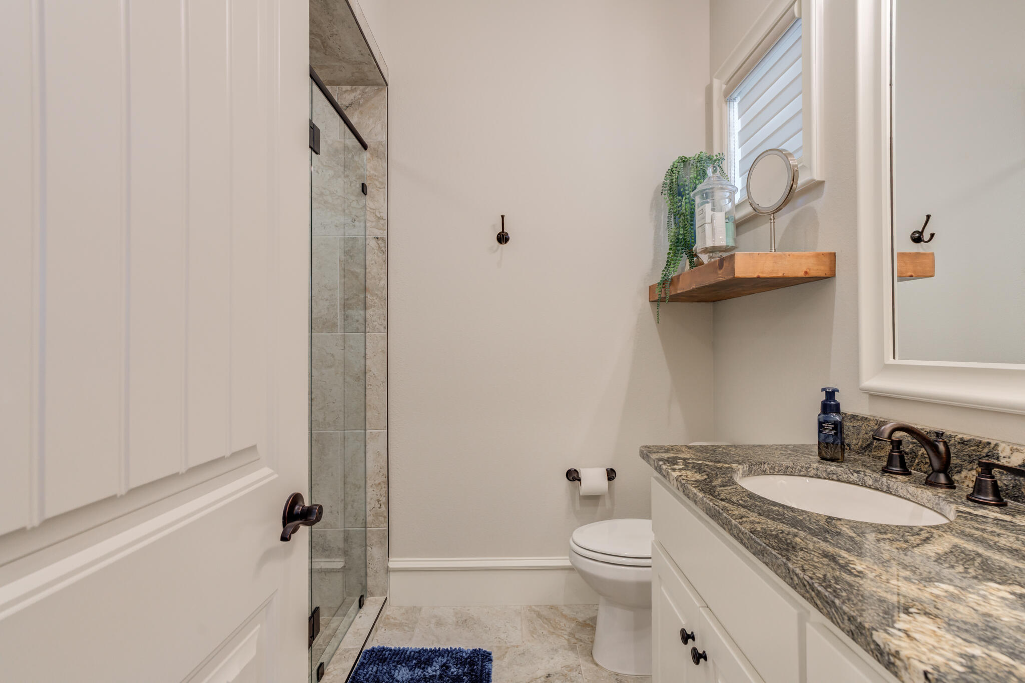 5006 117th Street Lubbock, TX 79424 - Photo 43 of 88 a bathroom with a granite countertop sink a toilet and shower