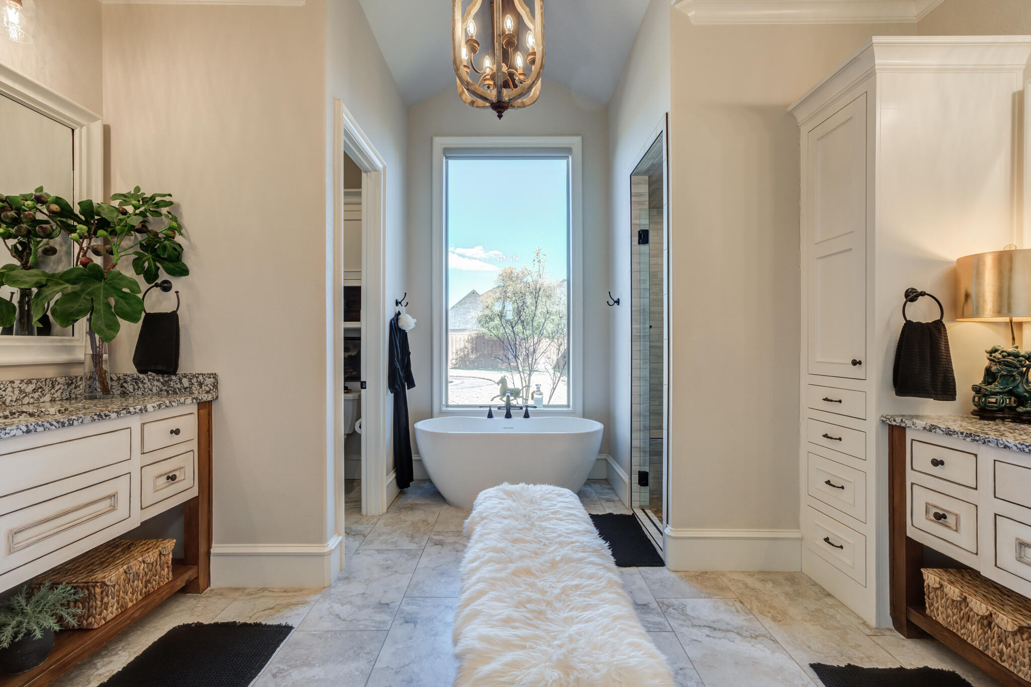 5006 117th Street Lubbock, TX 79424 - Photo 60 of 88 a spacious bathroom with a granite countertop sink and a mirror