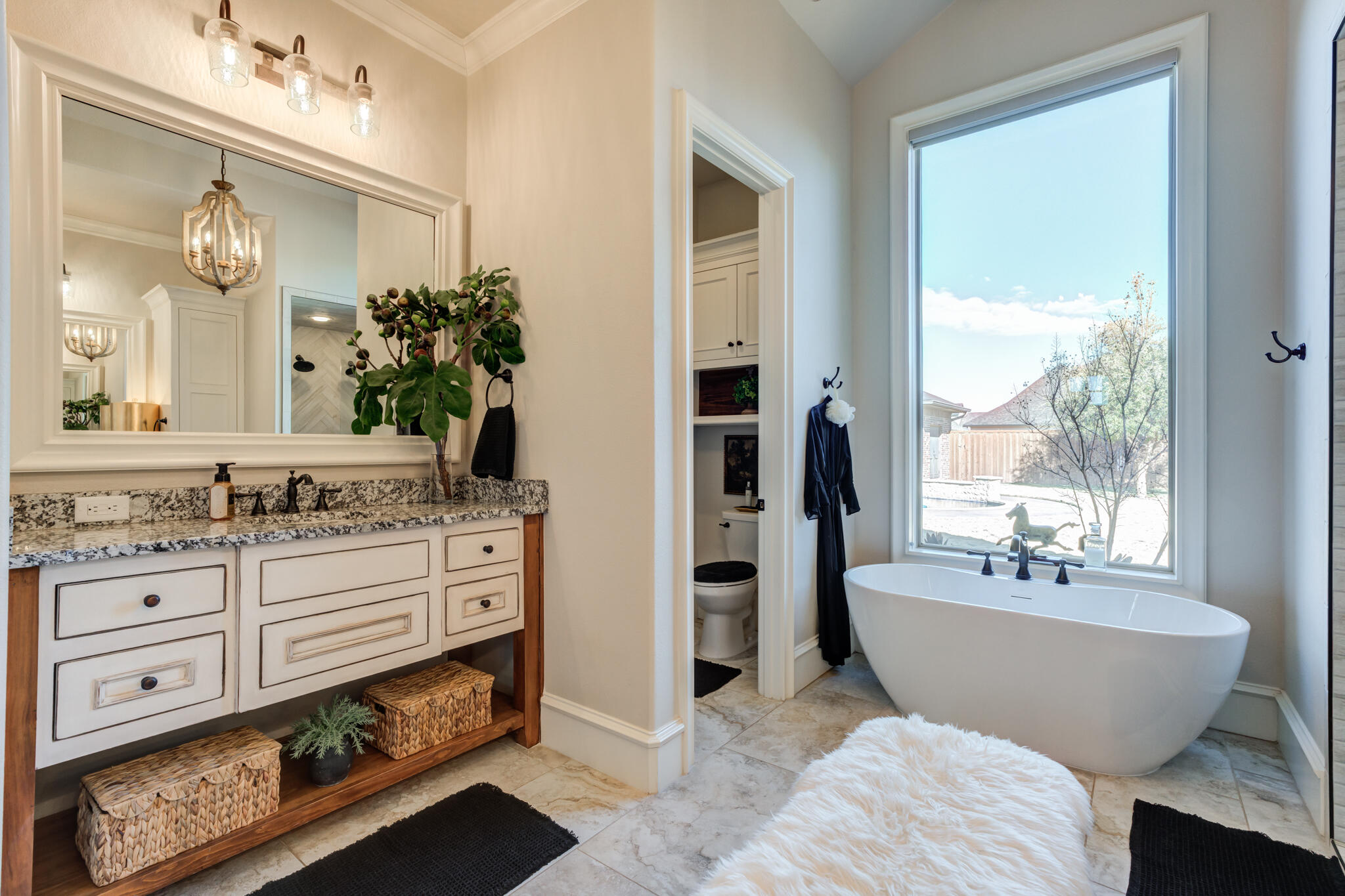 5006 117th Street Lubbock, TX 79424 - Photo 61 of 88 a spacious bathroom with a double vanity sink a mirror a bathtub and next to a window