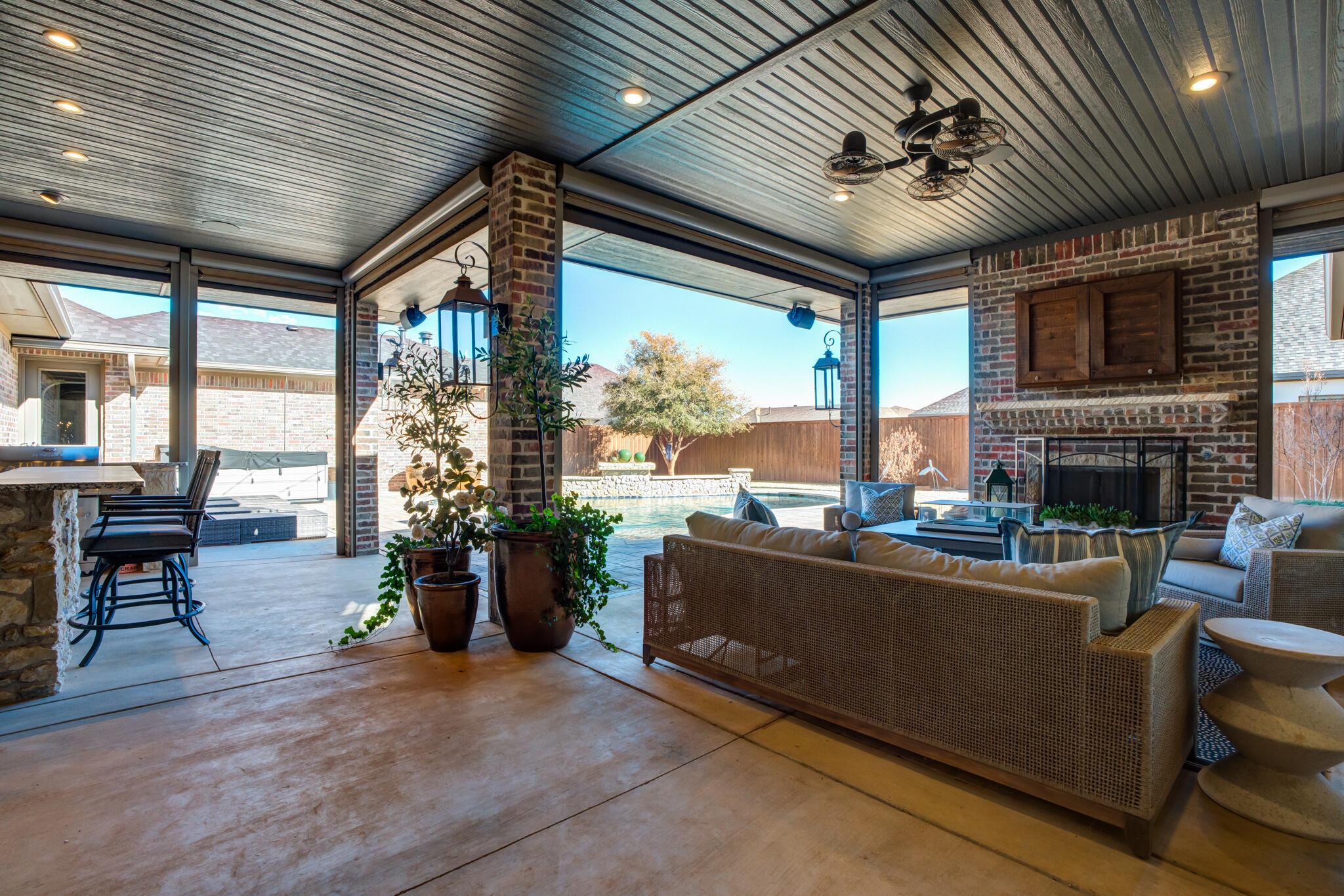 5006 117th Street Lubbock, TX 79424 - Photo 73 of 88 a living room with furniture fireplace and floor to ceiling windows