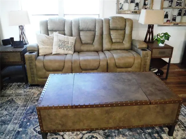 a view of a patio with table and chairs potted plants with wooden floor