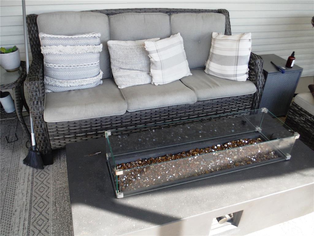 168 Pinewood Terrace, Unit 104 Safety Harbor, FL 34695 - Photo 19 of 55 a view of table and chair