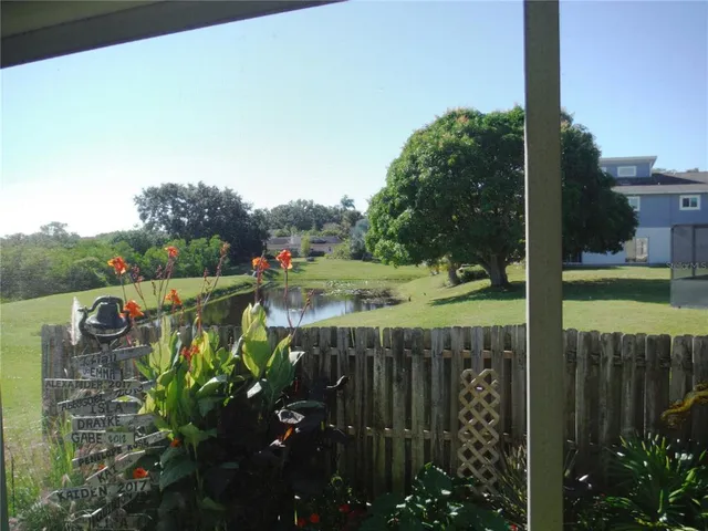 a view of a backyard with plants and flowers