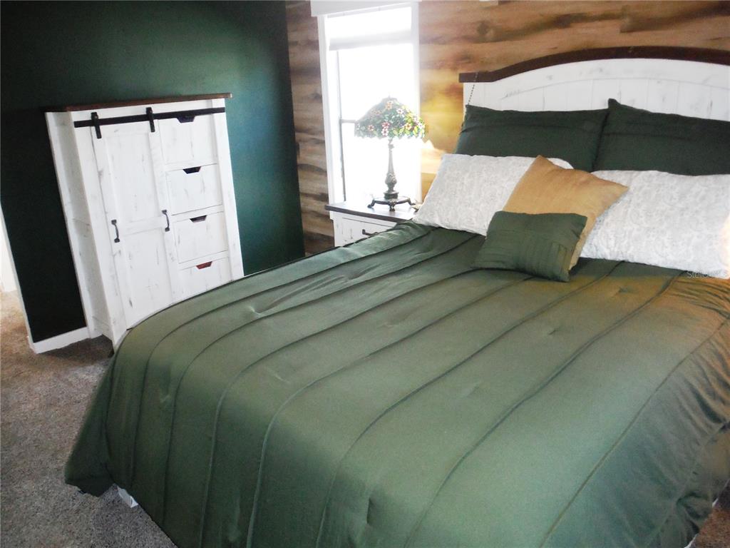 168 Pinewood Terrace, Unit 104 Safety Harbor, FL 34695 - Photo 27 of 55 a bed sitting in a bedroom next to a window