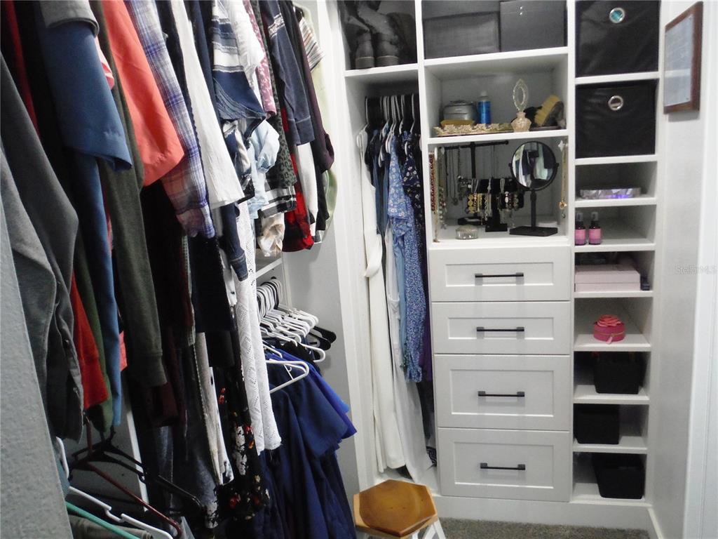 168 Pinewood Terrace, Unit 104 Safety Harbor, FL 34695 - Photo 28 of 55 a view of walk in closet with clothes and shoes