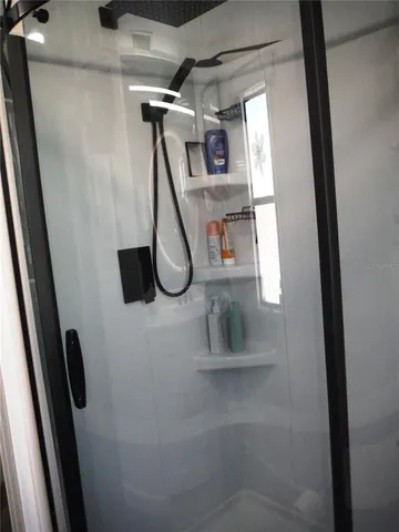 a bathroom with a shower a toilet and a sink