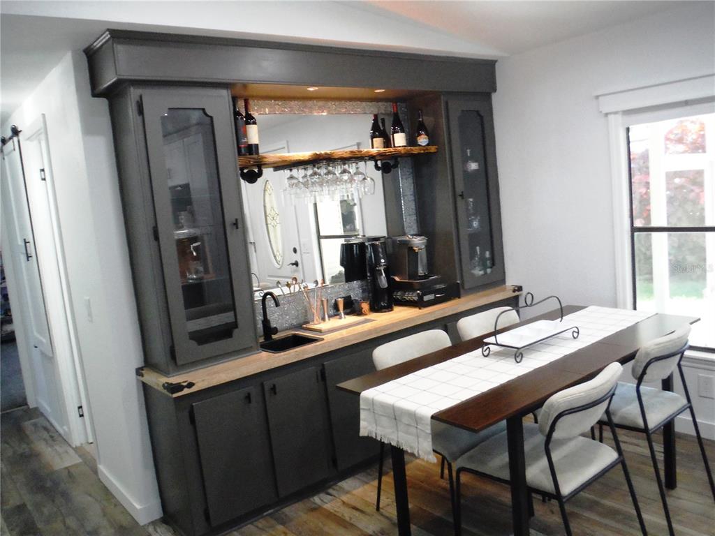 168 Pinewood Terrace, Unit 104 Safety Harbor, FL 34695 - Photo 3 of 55 a bathroom with a sink a mirror and a wooden cabinets