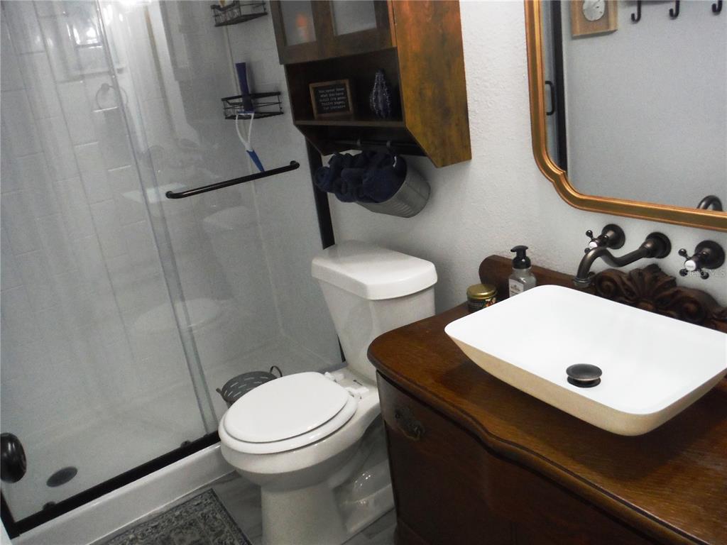 168 Pinewood Terrace, Unit 104 Safety Harbor, FL 34695 - Photo 35 of 55 a bathroom with a sink toilet and shower