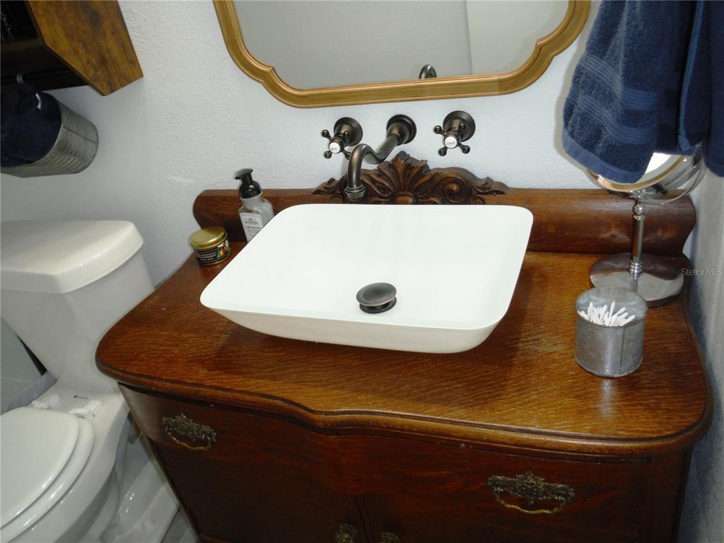 168 Pinewood Terrace, Unit 104 Safety Harbor, FL 34695 - Photo 36 of 55 a bathroom with a sink and a mirror