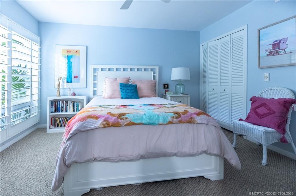 245 Northeast MacArthur Boulevard, Unit 18 Stuart, FL 34996 - Photo 4 of 15 a bedroom with a bed and a window