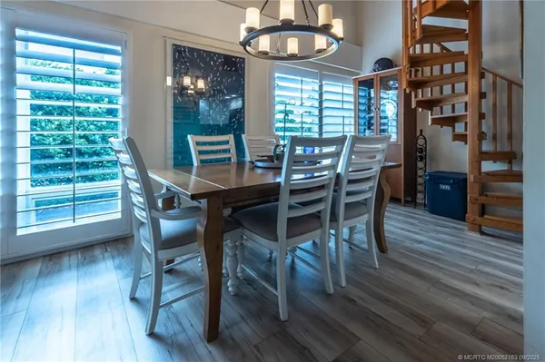 a kitchen with stainless steel appliances granite countertop a sink a stove a microwave a refrigerator and cabinets