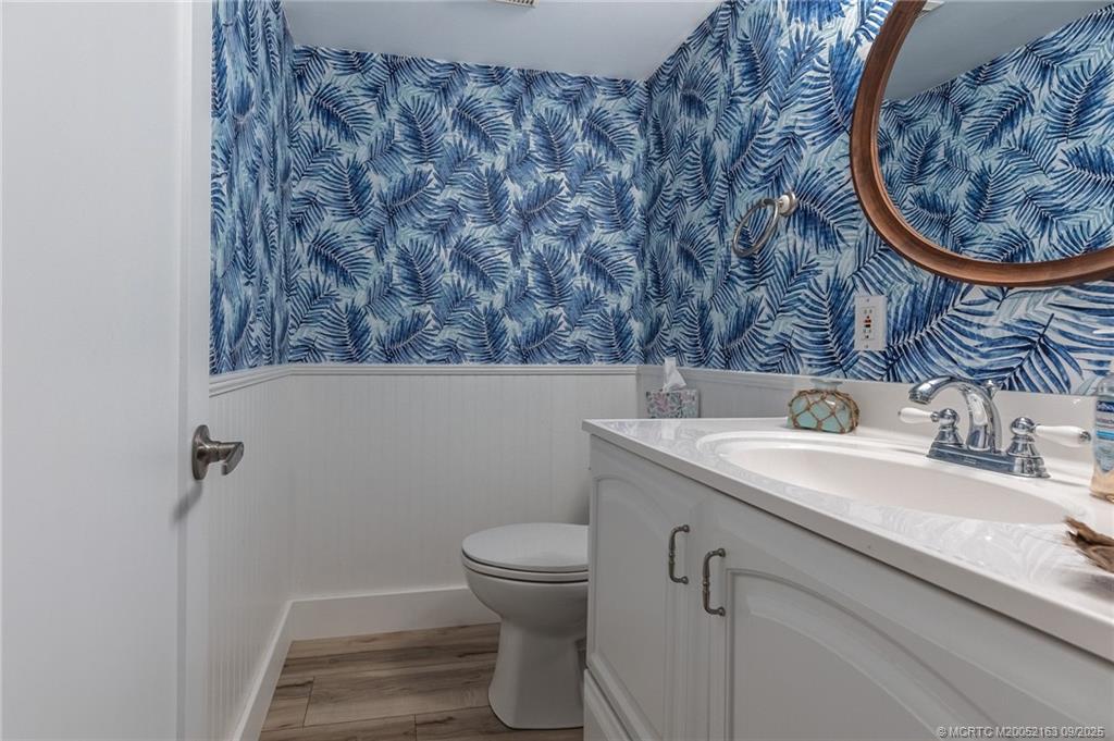 245 Northeast MacArthur Boulevard, Unit 18 Stuart, FL 34996 - Photo 8 of 15 a bathroom with a sink and a toilet