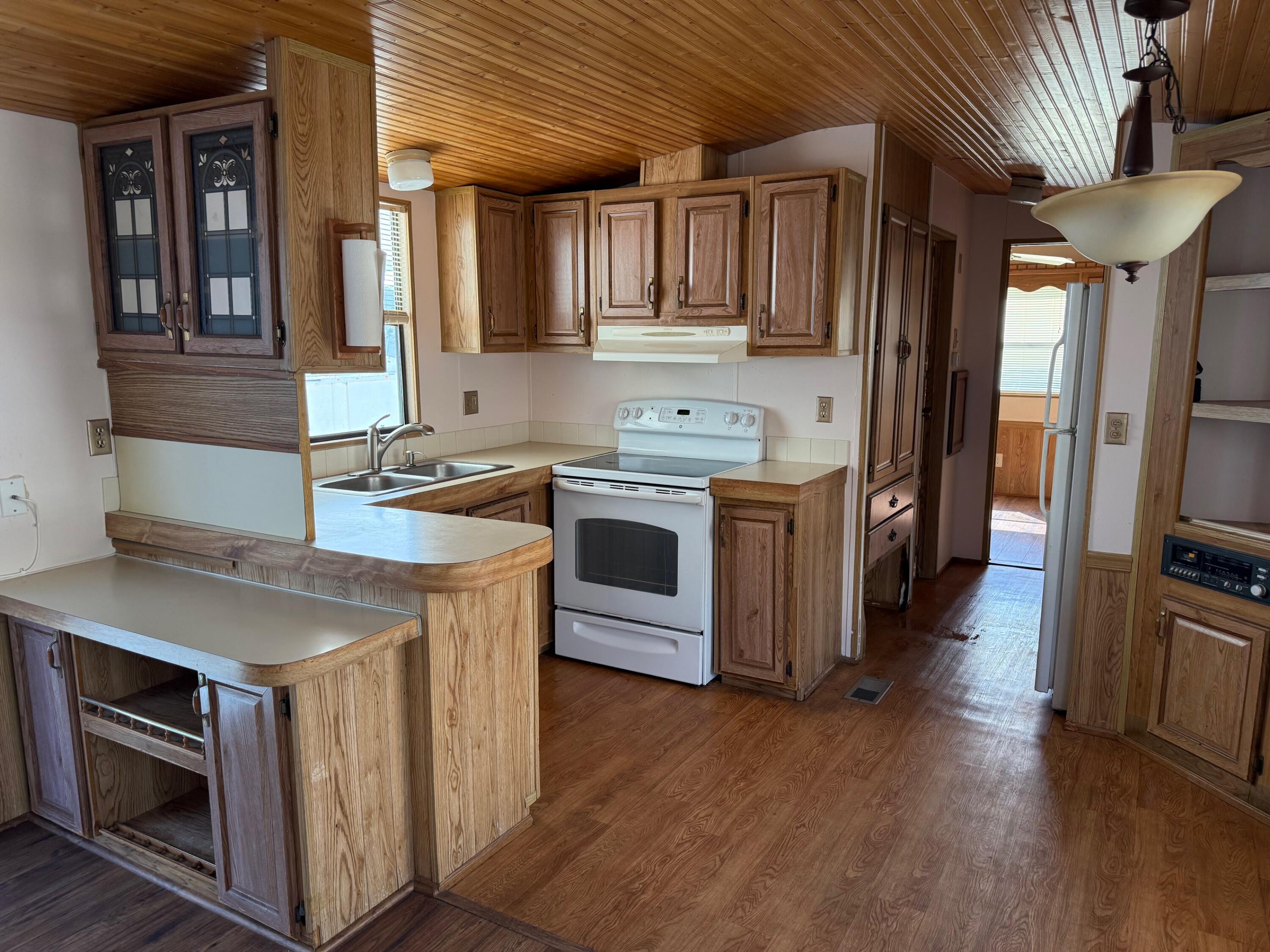 55 Boca Chica Road, Unit 57 Key West, FL 33040 - Photo 3 of 20 a kitchen with stainless steel appliances a stove a sink and a refrigerator