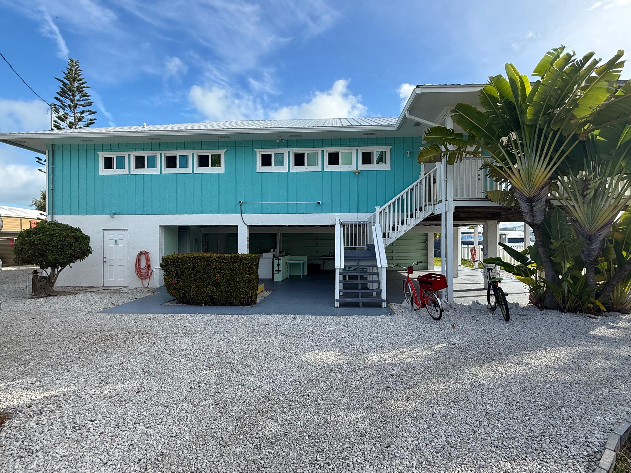 55 Boca Chica Road, Unit 57 Key West, FL 33040 - Photo 10 of 20 a view of a house with a patio and a yard