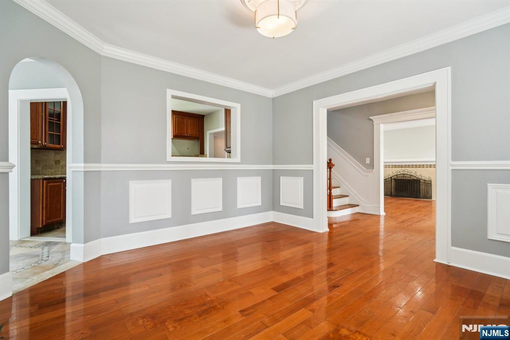 217 Grayson Place Teaneck, NJ 07666 - Photo 11 of 40 a view of an empty room with wooden floor and a window