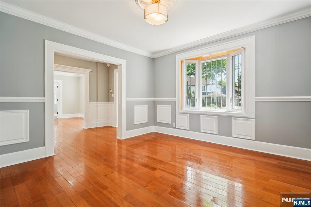 217 Grayson Place Teaneck, NJ 07666 - Photo 12 of 40 a view of an empty room with window and wooden floor