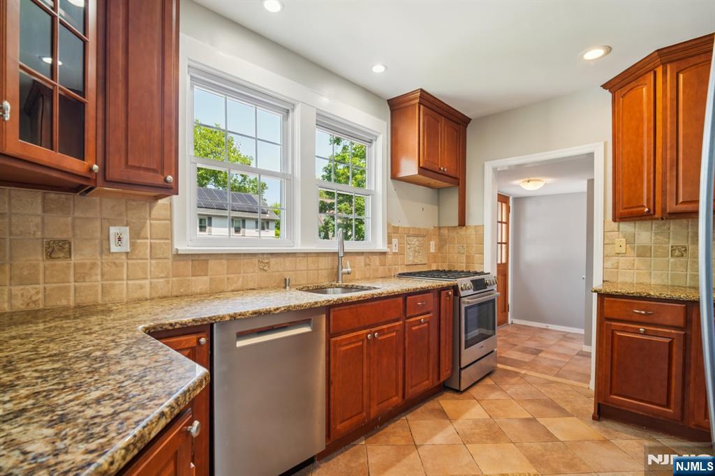 217 Grayson Place Teaneck, NJ 07666 - Photo 13 of 40 a kitchen with a sink stove and cabinets