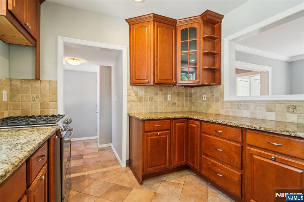 217 Grayson Place Teaneck, NJ 07666 - Photo 15 of 40 a kitchen with stainless steel appliances granite countertop a stove and a sink