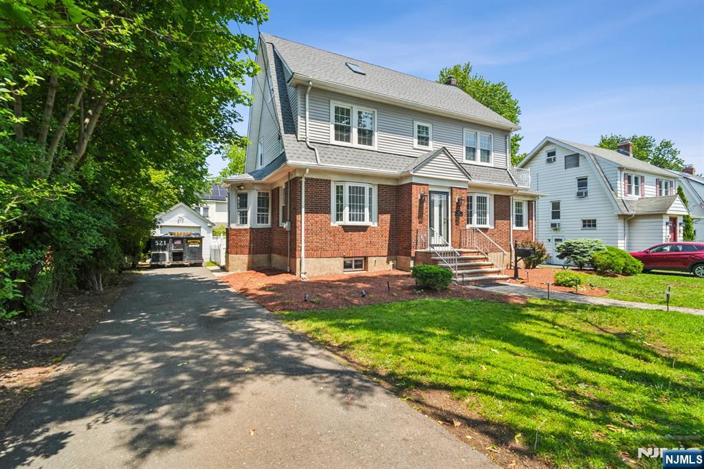 217 Grayson Place Teaneck, NJ 07666 - Photo 2 of 40 a front view of a house with a yard and porch