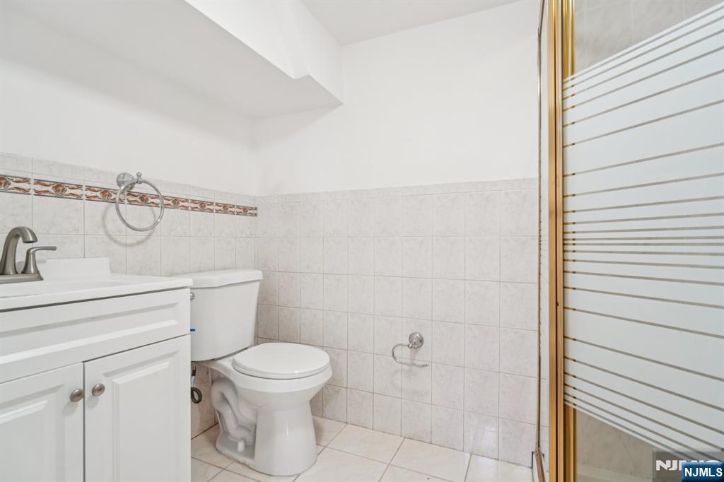 217 Grayson Place Teaneck, NJ 07666 - Photo 25 of 40 a bathroom with a toilet and a sink