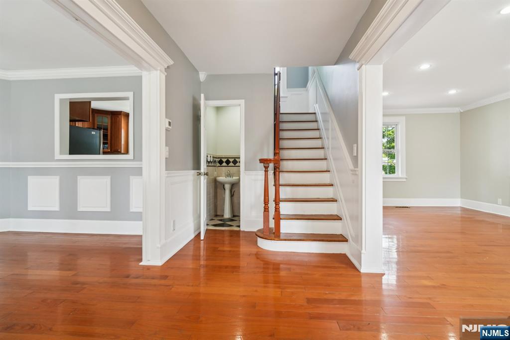 217 Grayson Place Teaneck, NJ 07666 - Photo 3 of 40 a view of a room with wooden floor and stairs