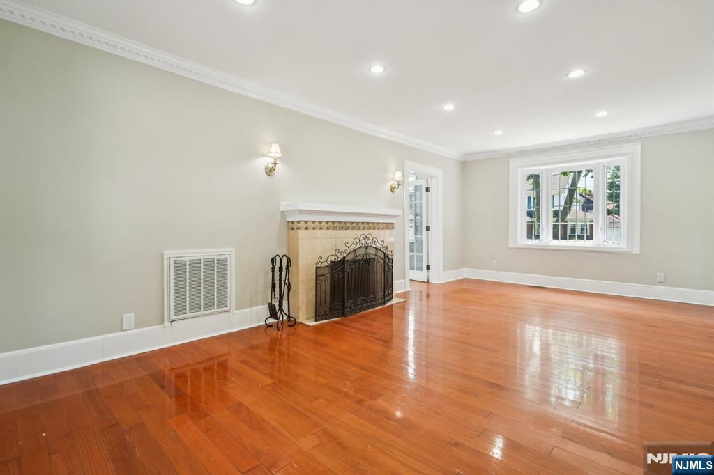 217 Grayson Place Teaneck, NJ 07666 - Photo 7 of 40 a view of a livingroom with a fireplace and wooden floor