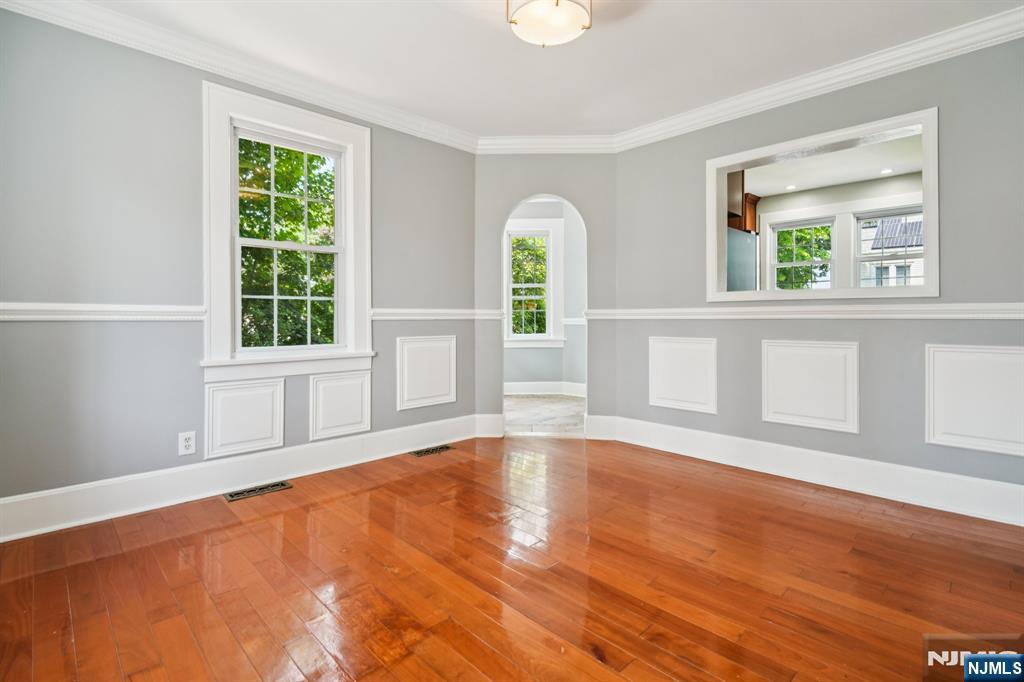 217 Grayson Place Teaneck, NJ 07666 - Photo 10 of 40 a view of an empty room with wooden floor and a window