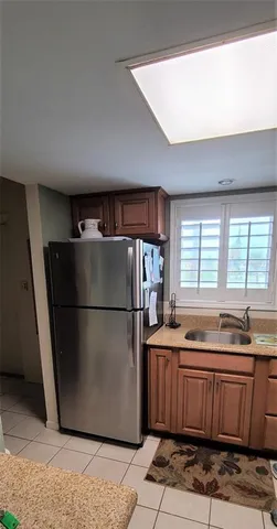 a kitchen with a refrigerator and a sink