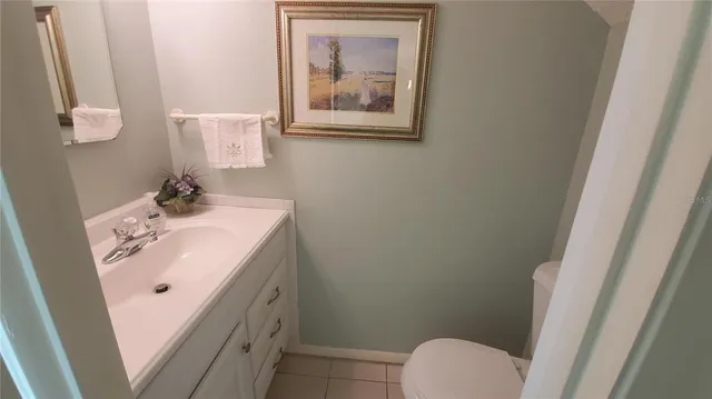 a bathroom with a sink and mirror with toilet