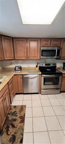 a kitchen with a sink a stove a microwave and cabinets