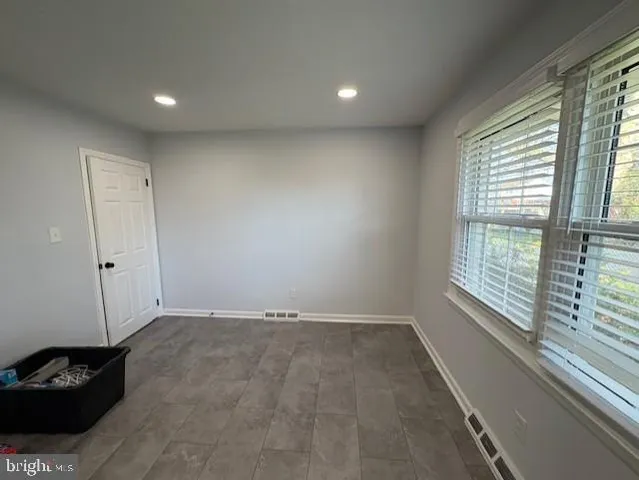 a view of an empty room and a window