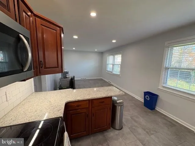 a spacious bedroom with a bed and a dresser next to a window
