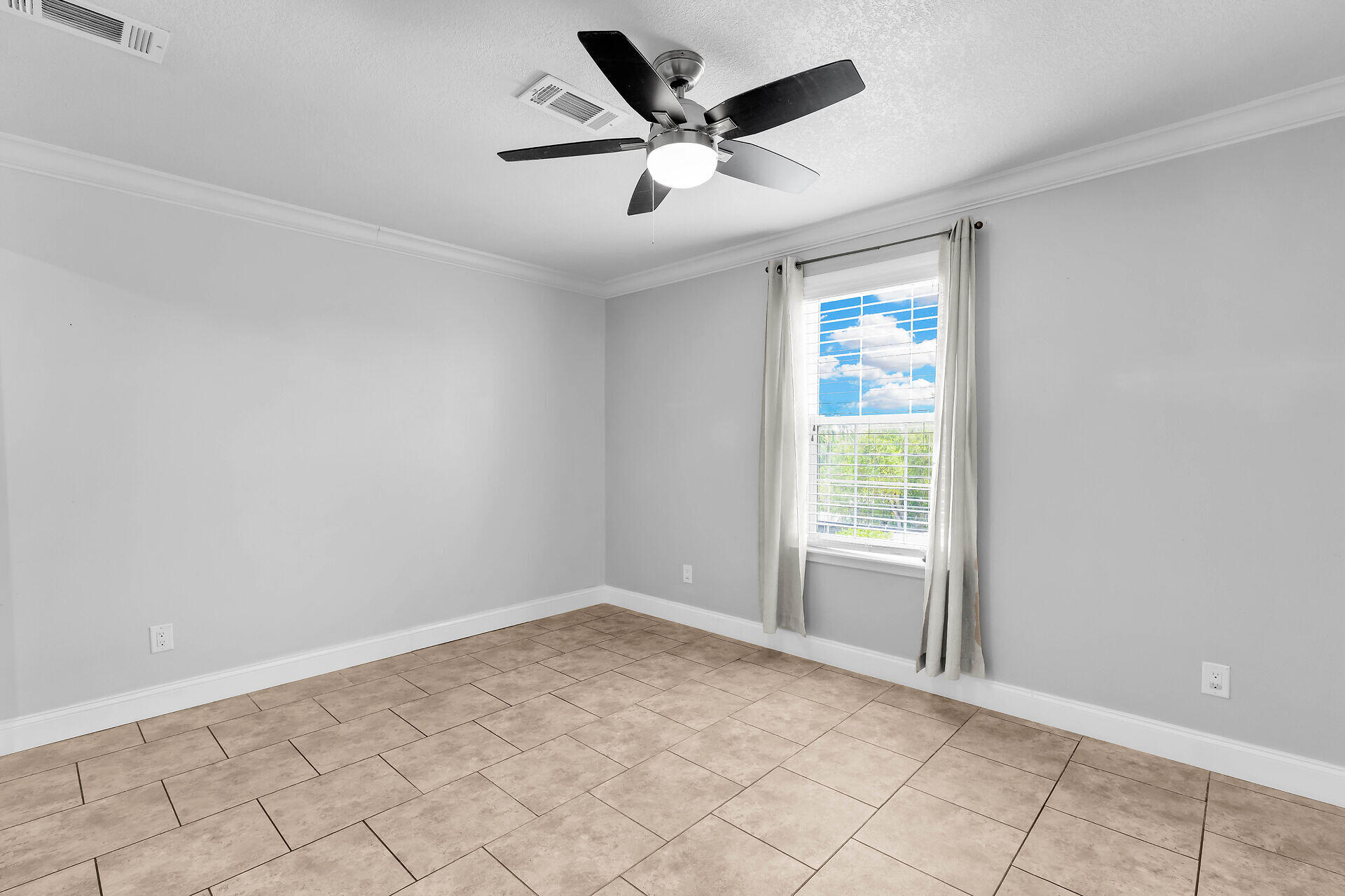 59 Ed Swift Road Key West, FL 33040 - Photo 19 of 35 wooden floor in an empty room with a window