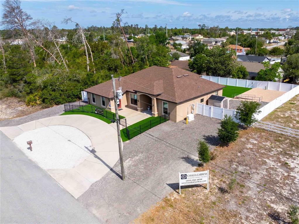 Undisclosed Address Spring Hill, FL 34608 - Photo 35 of 39 an aerial view of a house with a garden and trees