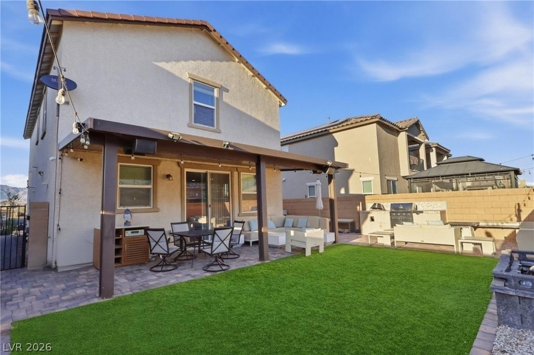 1921 Miller Ridge Avenue North Las Vegas, NV 89031 - Photo 23 of 26 This outdoor space features a covered patio and a well-maintained lawn, perfect for entertaining.