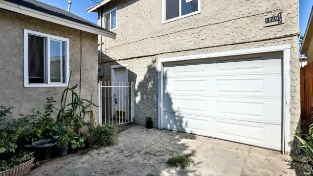 a view of a house with a door and a bench