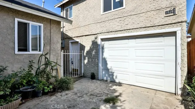 a view of a house with a door and a bench