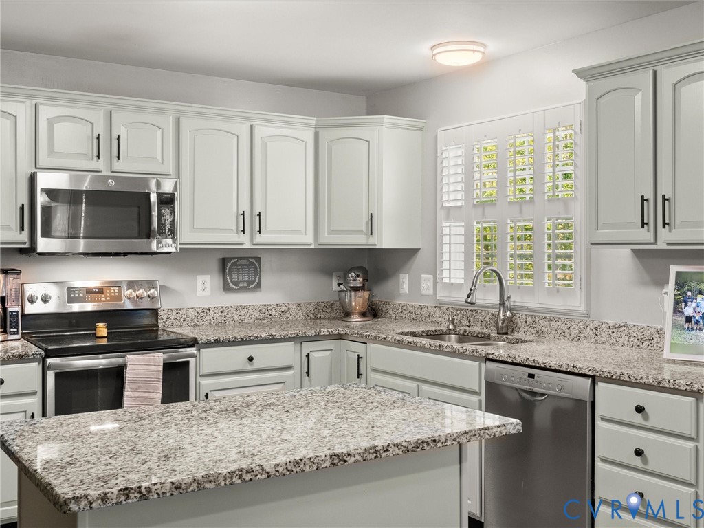 126 Reedy Creek Road Louisa, VA 23093 - Photo 21 of 65 The kitchen features white cabinetry with black ha