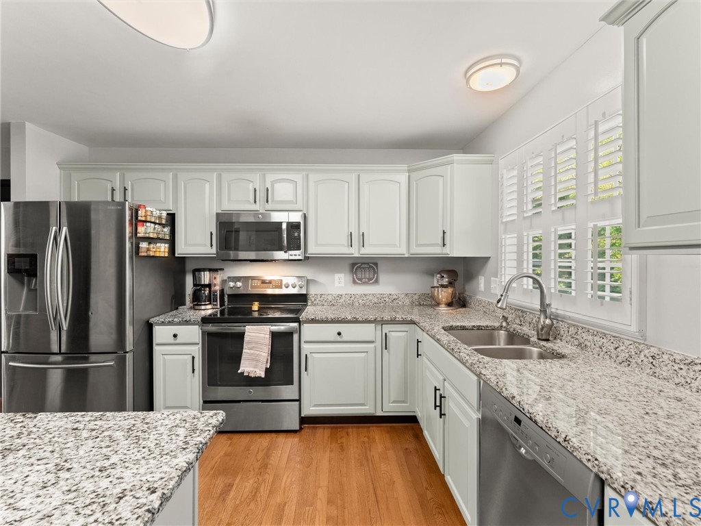 126 Reedy Creek Road Louisa, VA 23093 - Photo 25 of 65 The kitchen features light-colored cabinetry, stai