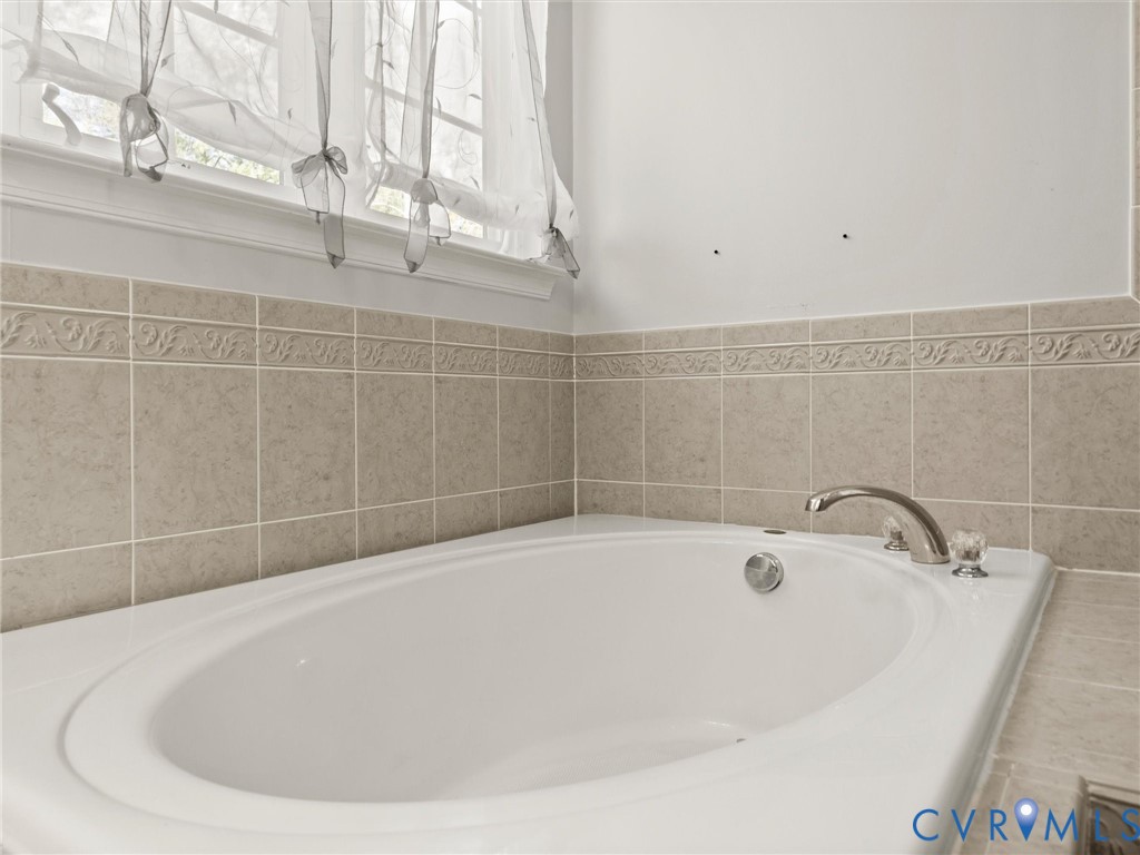 126 Reedy Creek Road Louisa, VA 23093 - Photo 43 of 65 Soaking tub with chrome fixtures, surrounded by be