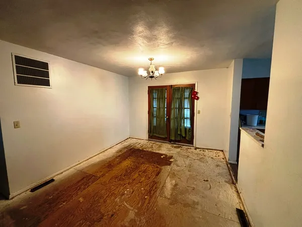 a view of an empty room with a fireplace