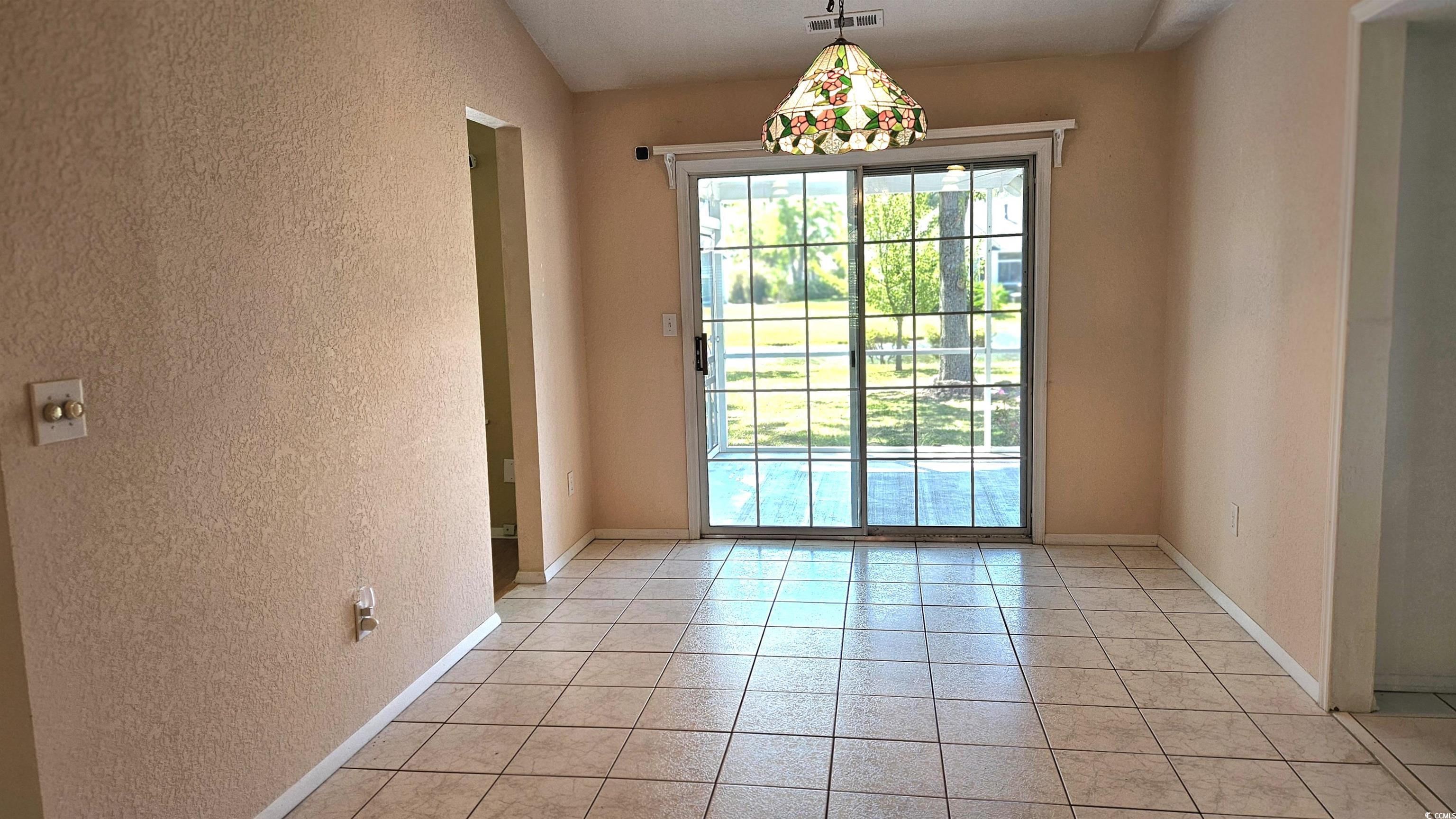 545 Saluda River Road Myrtle Beach, SC 29588 - Photo 11 of 25 Empty room featuring a textured wall and light tile patterned flooring