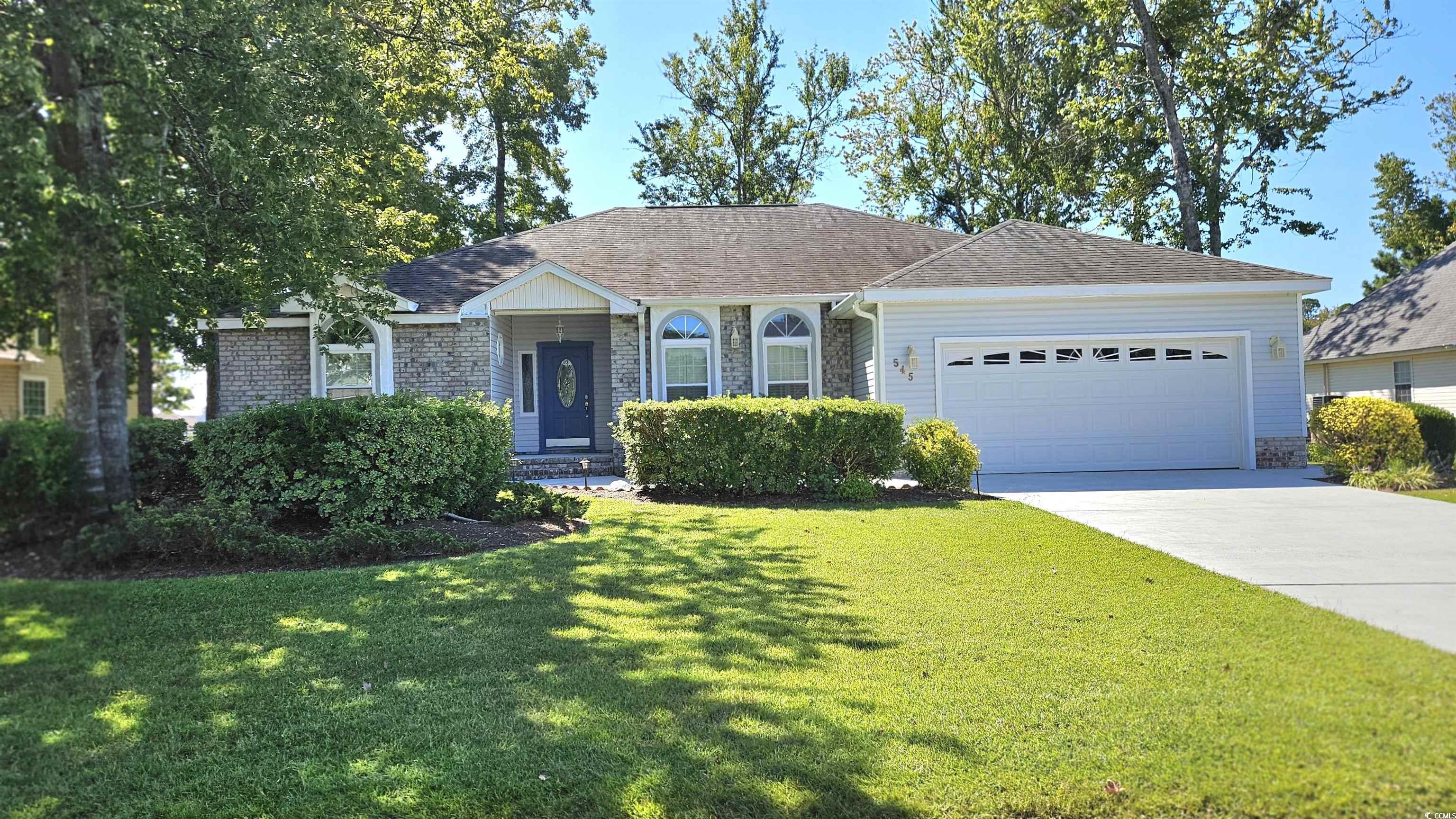 545 Saluda River Road Myrtle Beach, SC 29588 - Photo 2 of 25 Single story home featuring a front yard, a garage, a shingled roof, driveway, and brick siding