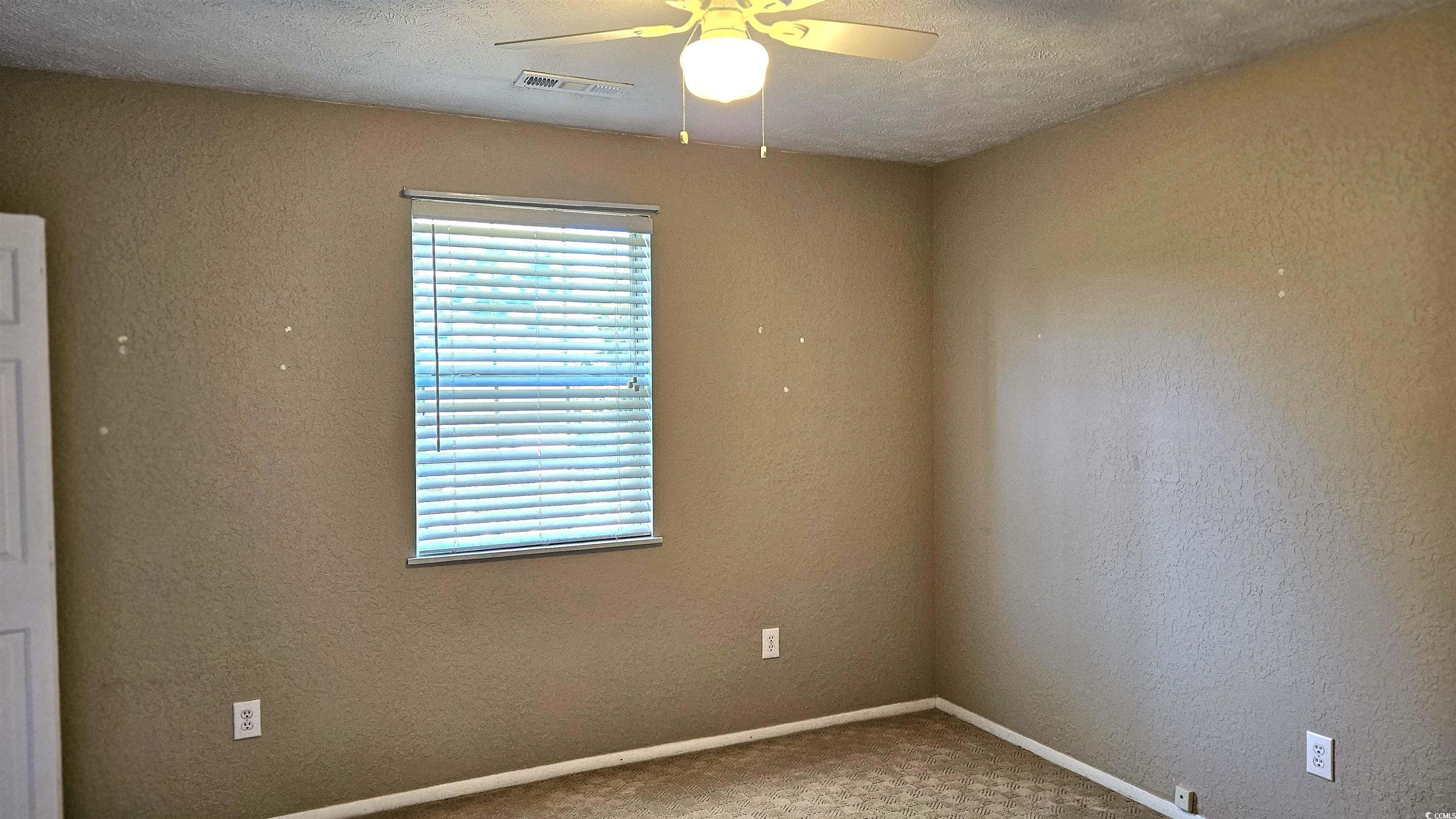 545 Saluda River Road Myrtle Beach, SC 29588 - Photo 22 of 25 Carpeted empty room with a textured wall, a textured ceiling, and ceiling fan