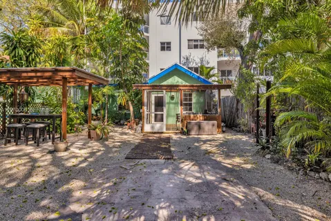 a view of a patio with table and chairs under an umbrella