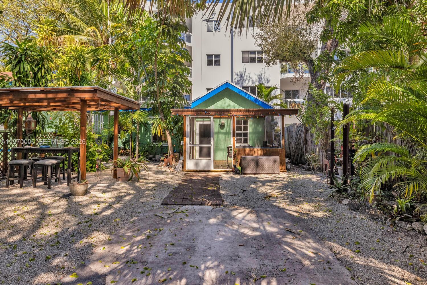 645 Northeast 62nd Street Miami, FL 33138 - Photo 23 of 32 a view of a patio with table and chairs under an umbrella