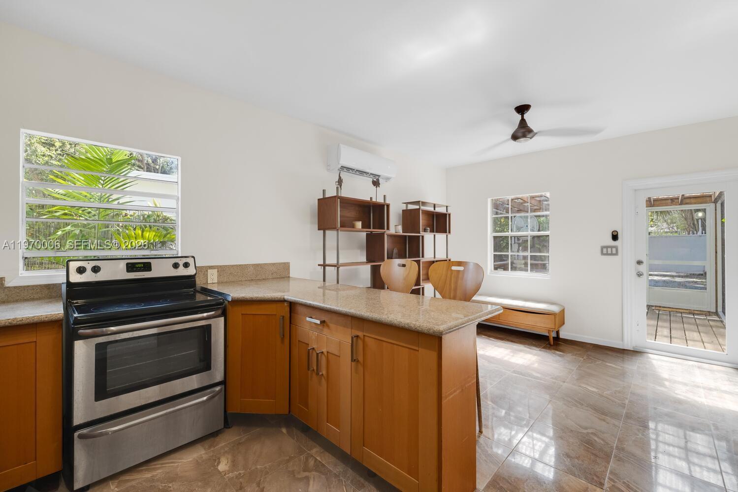 645 Northeast 62nd Street Miami, FL 33138 - Photo 27 of 32 a kitchen with stainless steel appliances granite countertop a stove and a sink