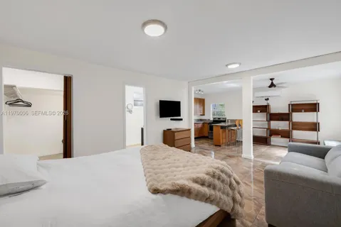 a bedroom with furniture and a flat screen tv