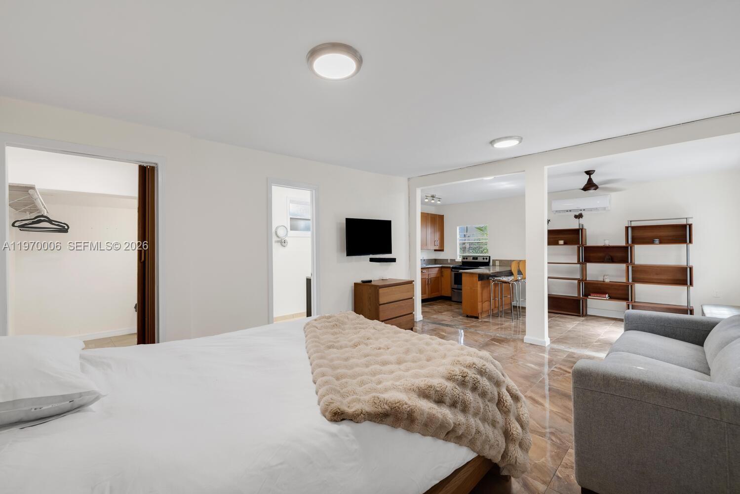 645 Northeast 62nd Street Miami, FL 33138 - Photo 28 of 32 a bedroom with furniture and a flat screen tv